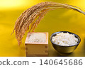 Rice served in a wooden box with a gold background, rice in a bowl, and rice stalks. 140645686