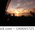 A sunrise over the ocean full of possibilities, while driving. 140645725