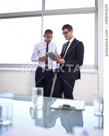 Business men, tablet and discussion on plan for project, office and collaboration on idea. Colleagues, teamwork and internet for online research, partnership and communication in meeting for support Business men, tablet and discussion on plan for project, office and collaboration on idea. Colleagues, teamwork and internet for online research, partnership and communication in meeting for support 140645829