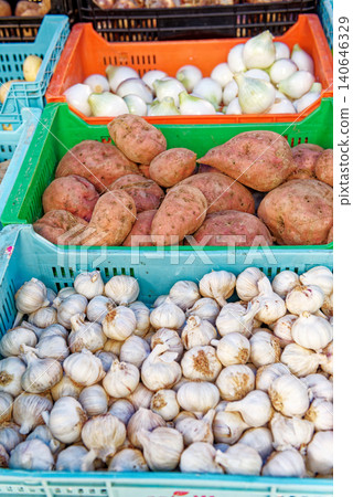 Fresh garlic, sweet potatoes, and white onions Fresh garlic, sweet potatoes, and white onions 140646329