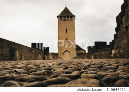 Cobblestone path leading to an ancient medieval tower Cobblestone path leading to an ancient medieval tower 140647011