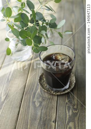 A natural lifestyle scene with iced coffee and eucalyptus. A natural lifestyle scene with iced coffee and eucalyptus. 140647113