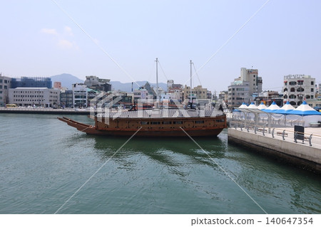 Traditional Boat in Harbor Cityscape 140647354