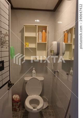 Modern Bathroom Interior with Toilet and Storage Cabinet 140647412