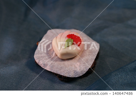 Delicate Flower-Decorated Dessert on Dark Base Delicate Flower-Decorated Dessert on Dark Base 140647486