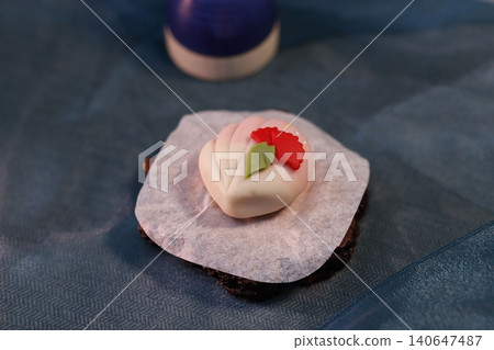 Delicate Flower-Decorated Dessert on Dark Base Delicate Flower-Decorated Dessert on Dark Base 140647487