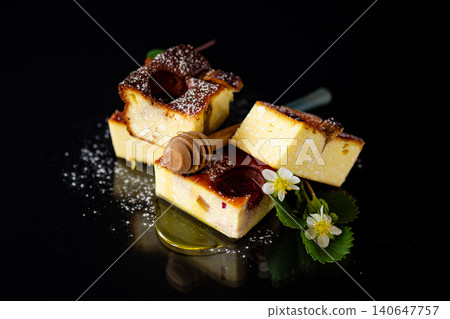 Rustic cottage cheese dessert with strawberries on black backdrop Rustic cottage cheese dessert with strawberries on black backdrop 140647757