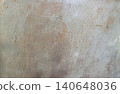 Rust patterns form on a metal surface creating a textured backdrop for a variety of potential artistic displays in a studio or workshop setting 140648036