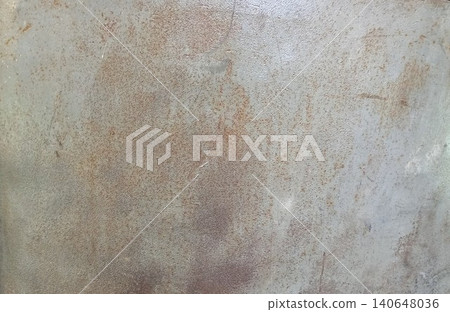 Rust patterns form on a metal surface creating a textured backdrop for a variety of potential artistic displays in a studio or workshop setting Rust patterns form on a metal surface creating a textured backdrop for a variety of potential artistic displays in a studio or workshop setting 140648036