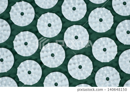 Macro abstract background of green acupuncture massage mat needles. 140648150