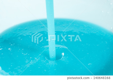 Pouring blue liquid detergent close up, abstract background. 140648168