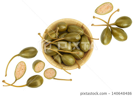 Capers in wooden bowl isolated on white background. Pickled or canned capers. Top view. Flat lay 140648486