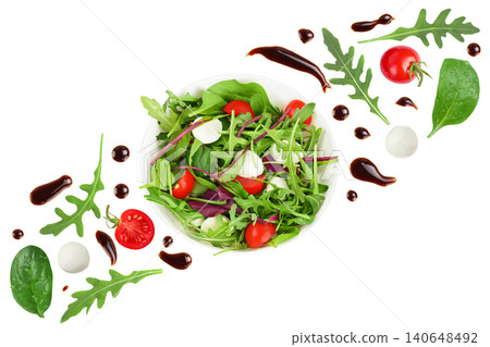 Mix salad - arugula, spinach, chard, cherry tomatoes and mozzarella in the bowl isolated on white background. Top view. Flat lay 140648492
