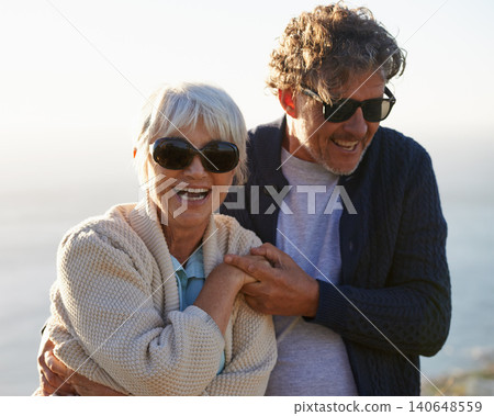 Happy, nature and senior couple with love for travel, tourism and holiday in retirement together. Coast, field and elderly people with smile for summer vacation, bonding and sunset walk in California 140648559