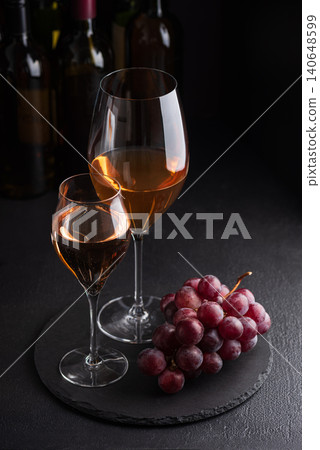 Tasting two types of rose wine with fresh grapes Tasting two types of rose wine with fresh grapes 140648599