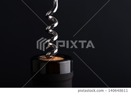 Corkscrew opening wine bottle with a cork 140648611