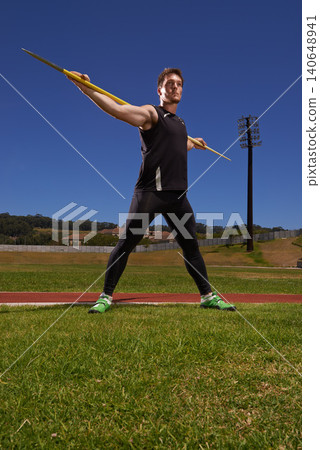 Man, athlete and javelin or sport exercise for competition on grass for workout fitness or outdoor, strength or training. Male person, challenge and target in arena for performance, aim or practice 140648941