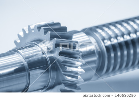 Close-up of a precision driving gear shaft part in a blue tone scene. 140650280