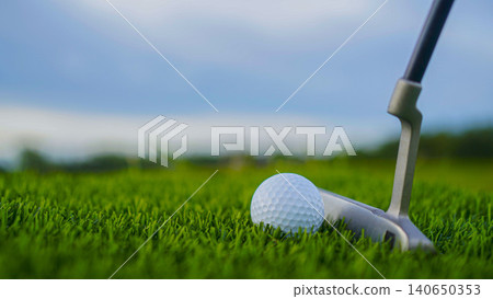 Golf clubs and balls on a green lawn in a beautiful golf course with morning sunshine. Golf clubs and balls on a green lawn in a beautiful golf course with morning sunshine. 140650353