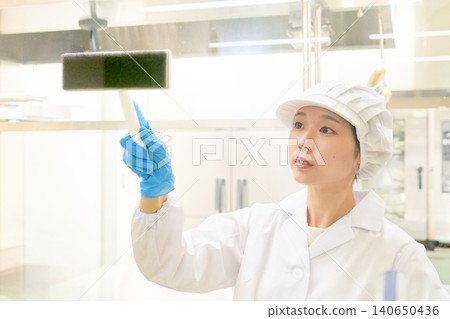 Staff performing cleaning duties in the kitchen Staff performing cleaning duties in the kitchen 140650436