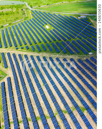 Large agricultural area equipped with extensive solar power systems. Expansive rural landscape featuring interconnected pathways and multiple terrain levels for solar panels Large agricultural area equipped with extensive solar power systems. Expansive rural landscape featuring interconnected pathways and multiple terrain levels for solar panels 140650630