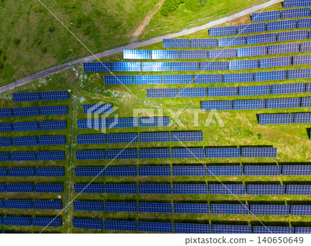 Drone captures solar panel layout. Aerial shot showcasing solar energy systems. Comprehensive aerial perspective revealing pattern and arrangement of solar module fields Drone captures solar panel layout. Aerial shot showcasing solar energy systems. Comprehensive aerial perspective revealing pattern and arrangement of solar module fields 140650649