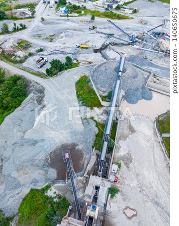 Aerial inspection of conveyor systems. Using drones to survey conveyor routes and stockpiles. Unmanned aerial vehicles mapping infrastructure and monitoring assets Aerial inspection of conveyor systems. Using drones to survey conveyor routes and stockpiles. Unmanned aerial vehicles mapping infrastructure and monitoring assets 140650675