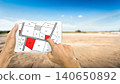 Man holding a tablet looking at lots of lands. Land plot management - real estate concept with vacant land for building construction and housing subdivision for sale, rent, buy, or investment. 140650892