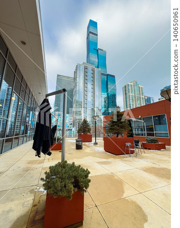 Urban rooftop view showing tall buildings and plant arrangements in a city during the day with grey clouds above Urban rooftop view showing tall buildings and plant arrangements in a city during the day with grey clouds above 140650961