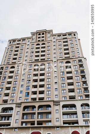 Charming facade with stylish features. Architectural elements highlight urban residential aesthetics. Sculpted archways and canopy details enhance city street appearance Charming facade with stylish features. Architectural elements highlight urban residential aesthetics. Sculpted archways and canopy details enhance city street appearance 140650995