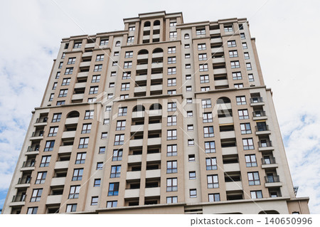 Symmetrical residential facade with repetitive arches and aligned balconies, highlighting proportion, rhythm and classicalinspired modern design for architectural use 140650996