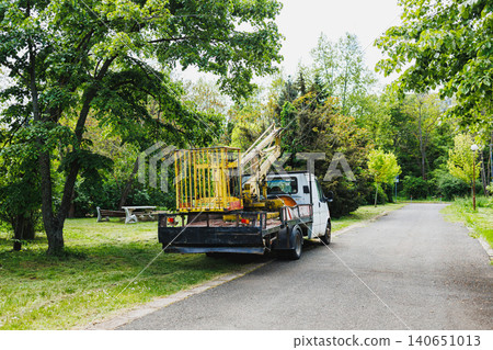 Country truck scene. Quiet rural setting with equipment. Peaceful countryside with parked vehicle and table. Serene rural environment featuring machinery and outdoor furniture Country truck scene. Quiet rural setting with equipment. Peaceful countryside with parked vehicle and table. Serene rural environment featuring machinery and outdoor furniture 140651013