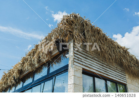 Distinctive rooftop shelter. Urban retreat with glass walls. Contemporary workspace overlooking sky and clouds. Modern studio featuring sustainable design and panoramic views 140651028