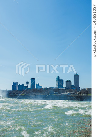 Visitors enjoy the view of Niagara Falls and the surrounding city on a bright sunny day in springtime Visitors enjoy the view of Niagara Falls and the surrounding city on a bright sunny day in springtime 140651057