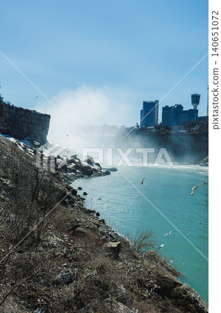 View of Niagara Falls with water mist and city skyline on a clear day in spring View of Niagara Falls with water mist and city skyline on a clear day in spring 140651072