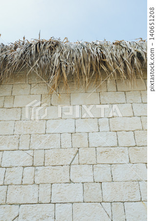 Rustic rural ambiance. Traditional thatched roofing complements limestone architecture beautifully. Picturesque village scene showcasing rural life and historic structures Rustic rural ambiance. Traditional thatched roofing complements limestone architecture beautifully. Picturesque village scene showcasing rural life and historic structures 140651208