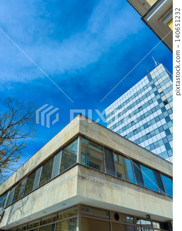 Building with large windows and blue sky in urban area on a sunny day with clear weather Building with large windows and blue sky in urban area on a sunny day with clear weather 140651232