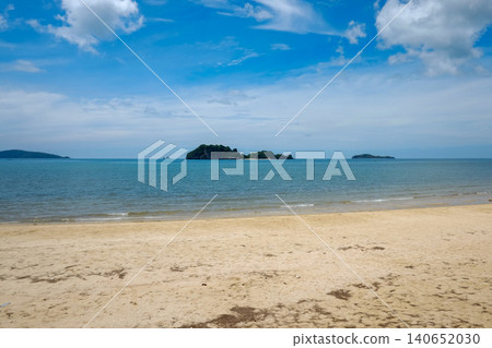 Tropical Sandy Beach with Islands and Turquoise Sea Under Blue Sky 140652030