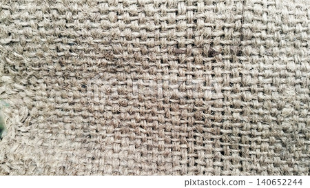 Close-up of rough hessian cloth surface, organic jute textile backdrop Close-up of rough hessian cloth surface, organic jute textile backdrop 140652244