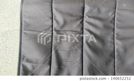 Close-up of dark black textile surface, elegant drapery material backdrop. Close-up of dark black textile surface, elegant drapery material backdrop. 140652252