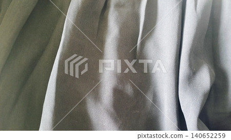 Close-up of dark black textile surface, elegant drapery material backdrop. 140652259