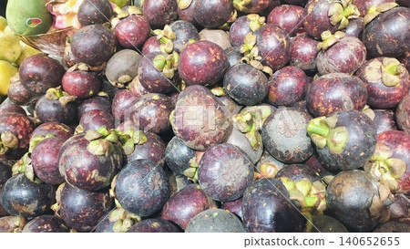 Fresh purple mangosteen fruits background at local market. Fresh purple mangosteen fruits background at local market. 140652655