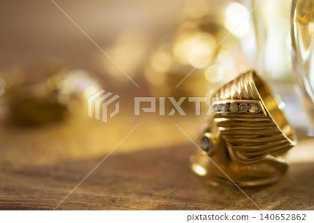 Elegant gold ring with diamonds on dark textured background Elegant gold ring with diamonds on dark textured background 140652862