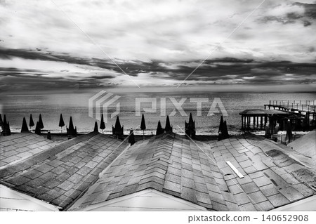 Closed beach resort umbrellas and cabins in winter monochrome landscape 140652908