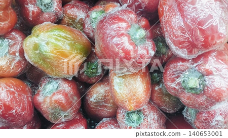 Fresh red bell peppers wrapped in plastic film background at supermarket Fresh red bell peppers wrapped in plastic film background at supermarket 140653001