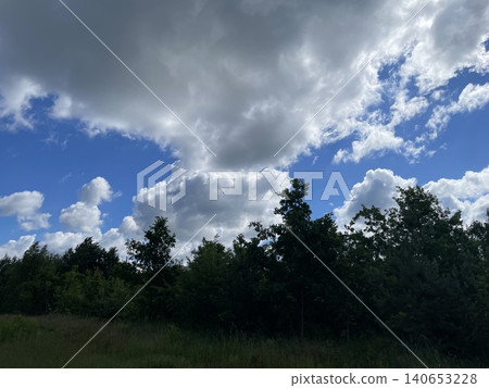Summer clouds over rural village Summer clouds over rural village 140653228