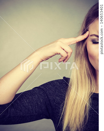 Closeup of woman thinking face expression Closeup of woman thinking face expression 140653401