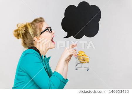 Bussines woman holding shopping cart with sweet bun Bussines woman holding shopping cart with sweet bun 140653433