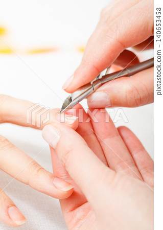 Preparing nails before manicure, cutting cuticles Preparing nails before manicure, cutting cuticles 140653458