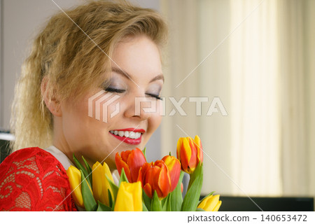 Woman holding bouquet of tulips flowers Woman holding bouquet of tulips flowers 140653472